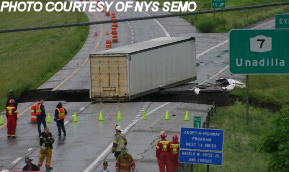 picture of truck over the washed out road