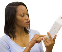 woman reading label on bottle