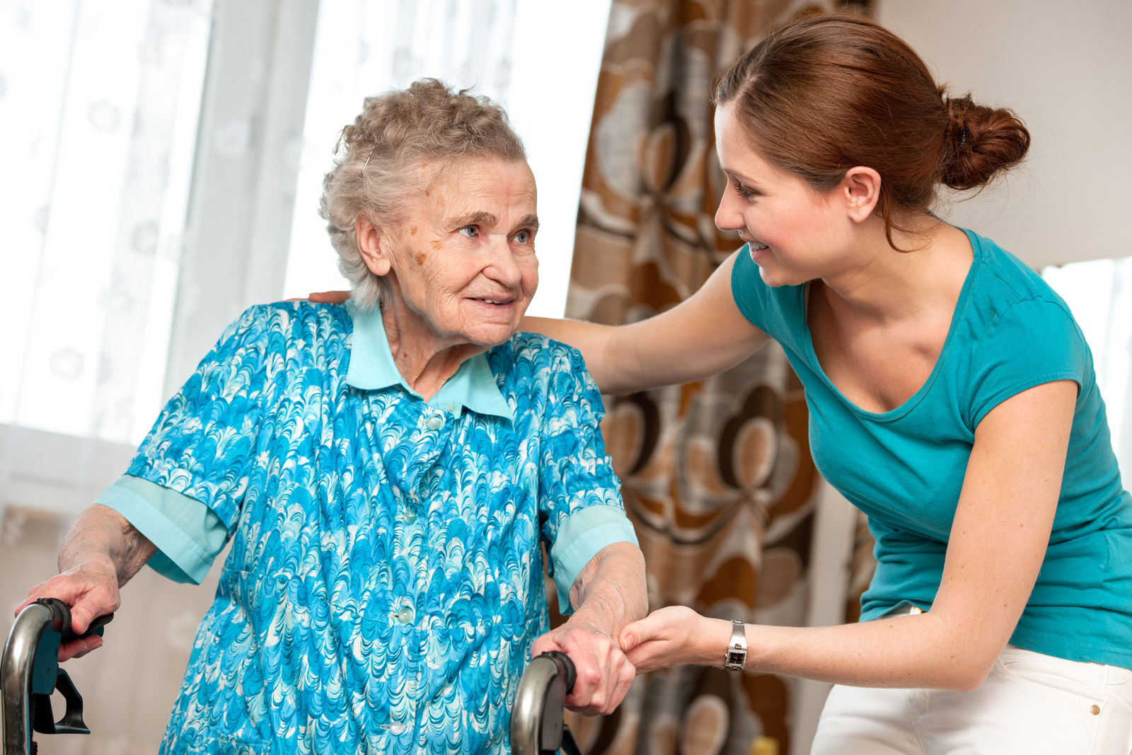 A nurse helping an elderly woman