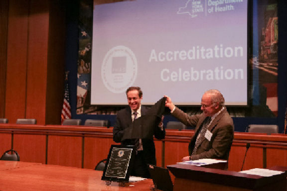 Image of the commissioner unveiling a plaque